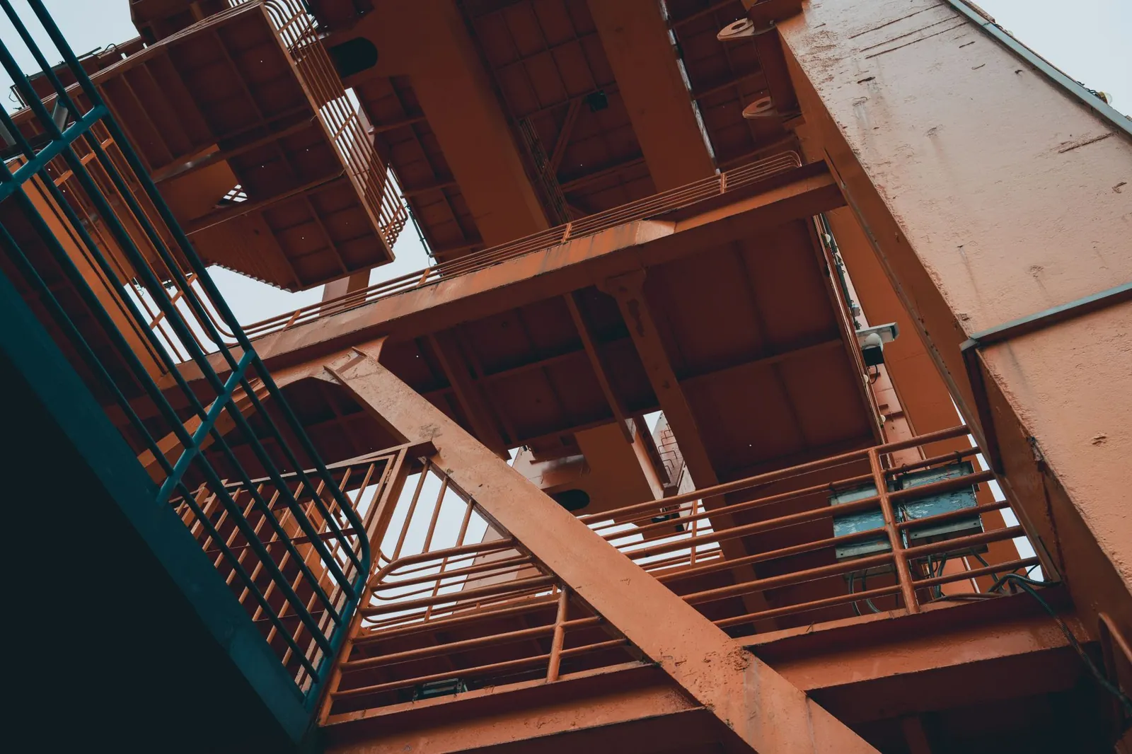 Close-up view of a large orange industrial metal structure with geometric angles and lines. Stock photo illustrating Karbonsteel Engineering's new order story.