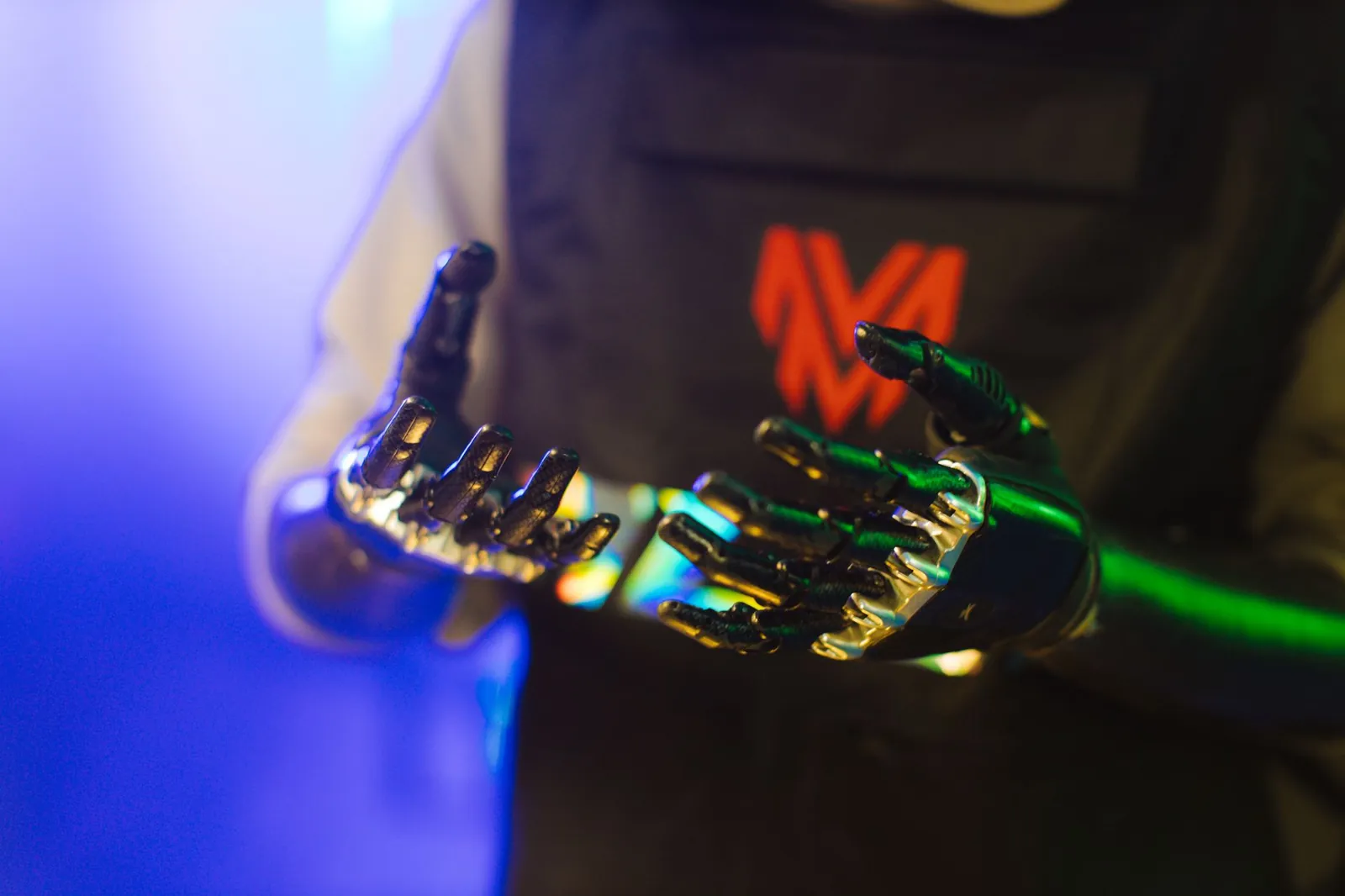 Close-up of robotic hands with metallic finish and neon lights, showcasing futuristic technology. Stock photo illustrating Max India's product launched story.