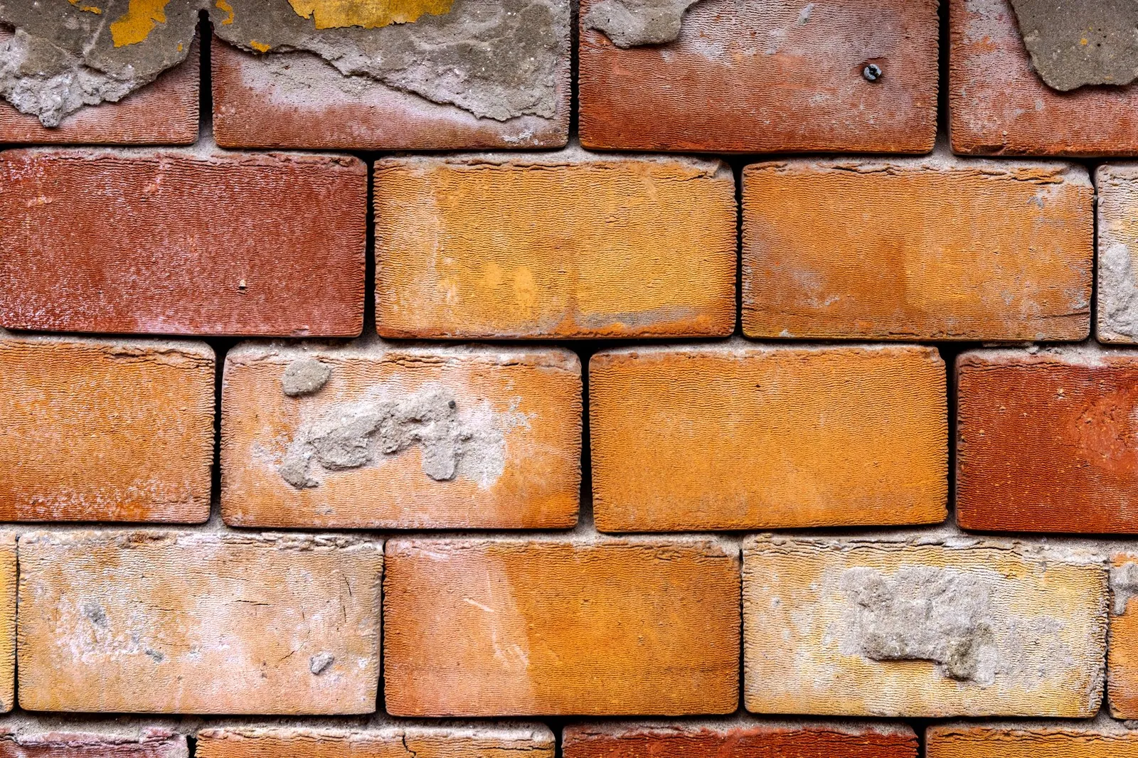 Detailed close-up of an aged brick wall, showcasing texture and construction pattern. Stock photo illustrating Gabion Technologies India's new order story.