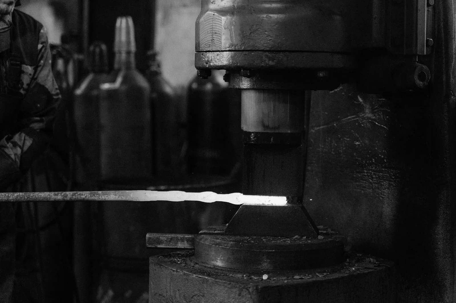 Monochrome image of a blacksmith's forge with metal being processed. Stock photo illustrating Bharat Forge's fund raise story.