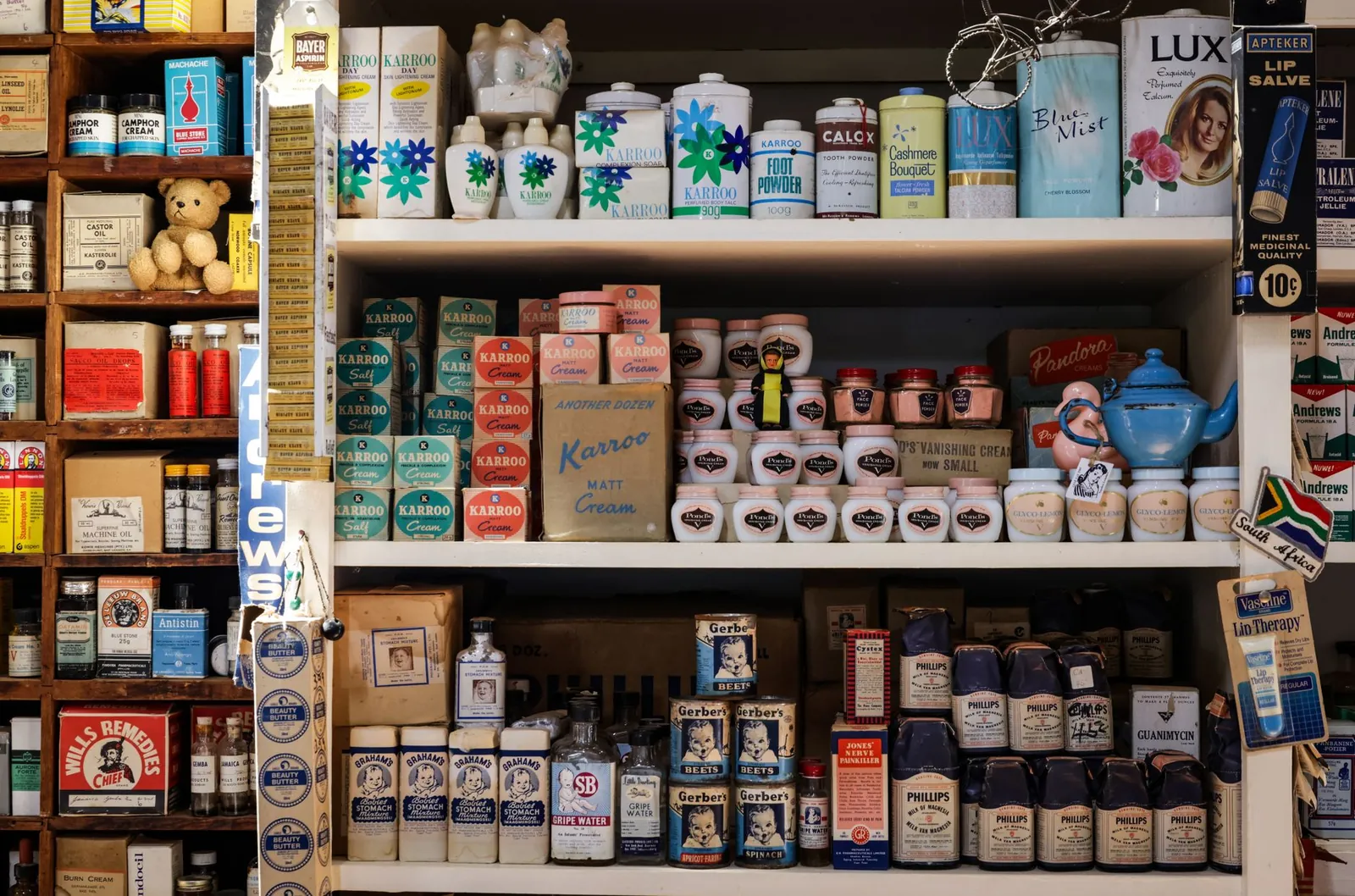 Retro grocery store shelves filled with vintage packaging and products. Stock photo illustrating Godrej Consumer Products' promoter buying story.