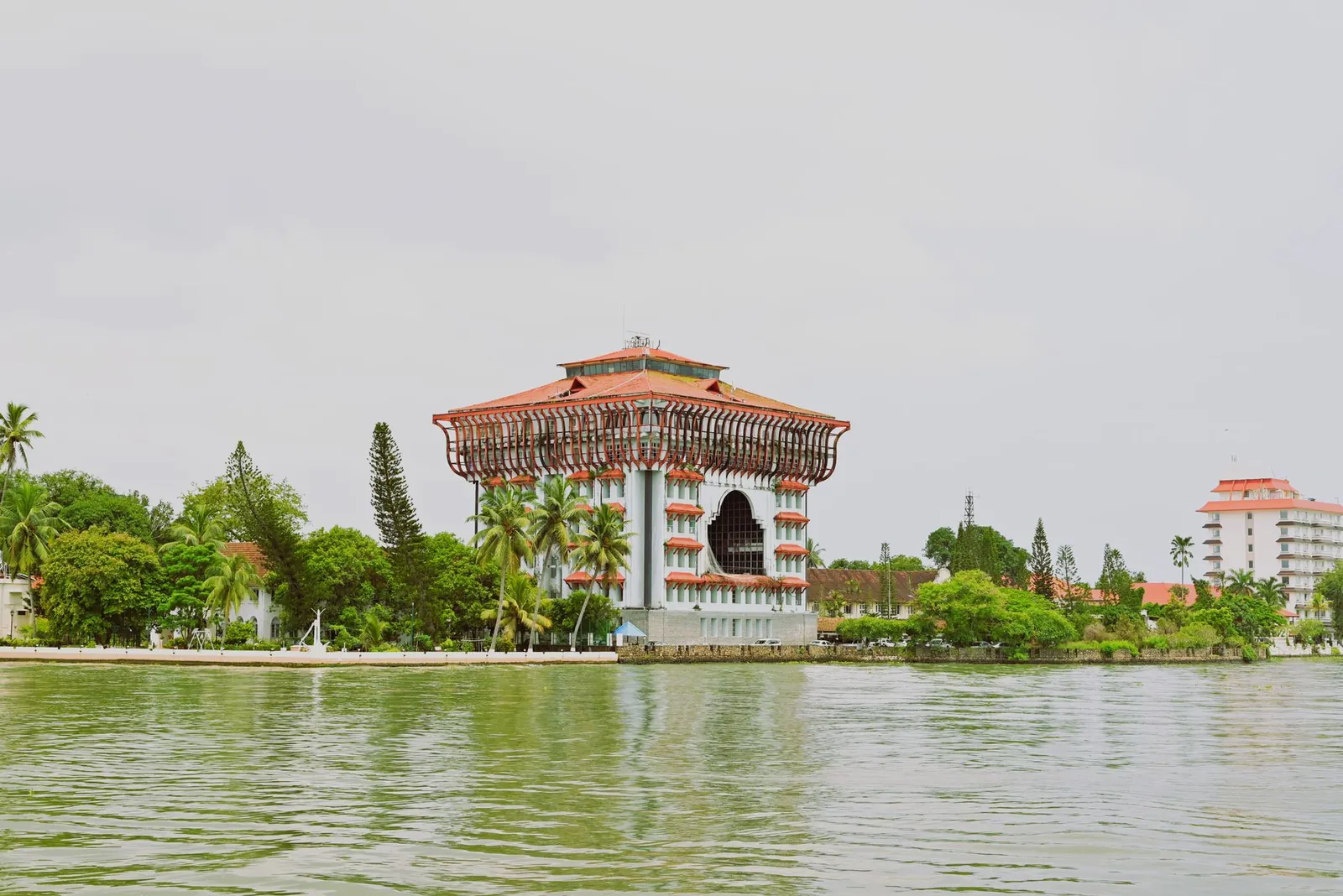 Stunning view of a landmark building in Kochi, Kerala, by a serene waterway. Stock photo illustrating Dhanlaxmi Bank's financial results story.