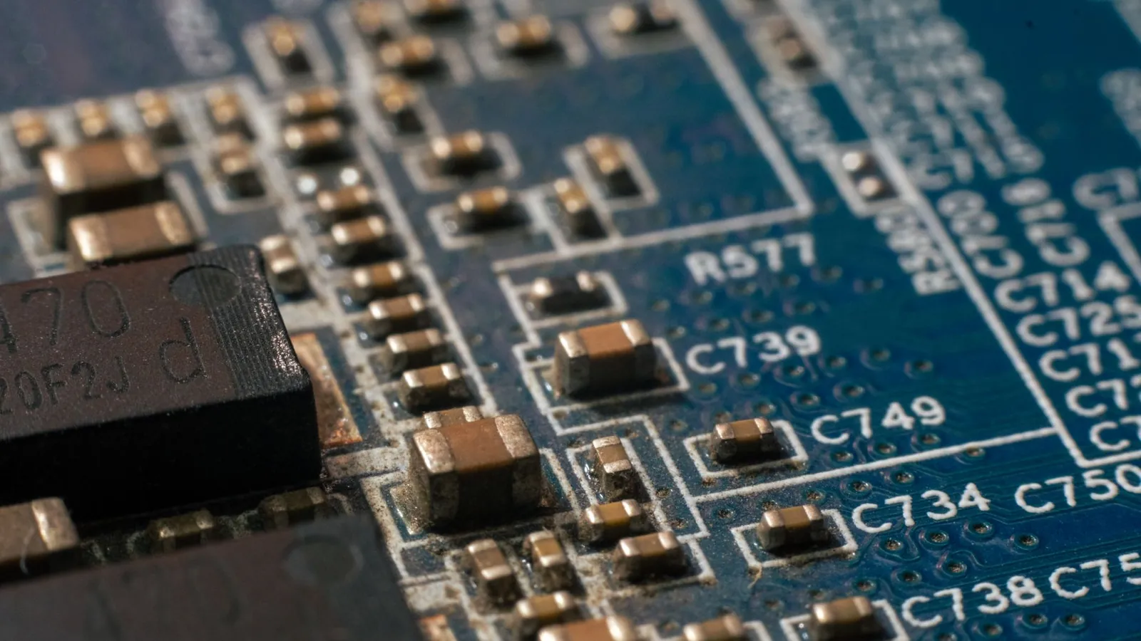 Detailed macro shot of a circuit board highlighting electronic components and traces. Stock photo illustrating Astra Microwave Products' earning call story.