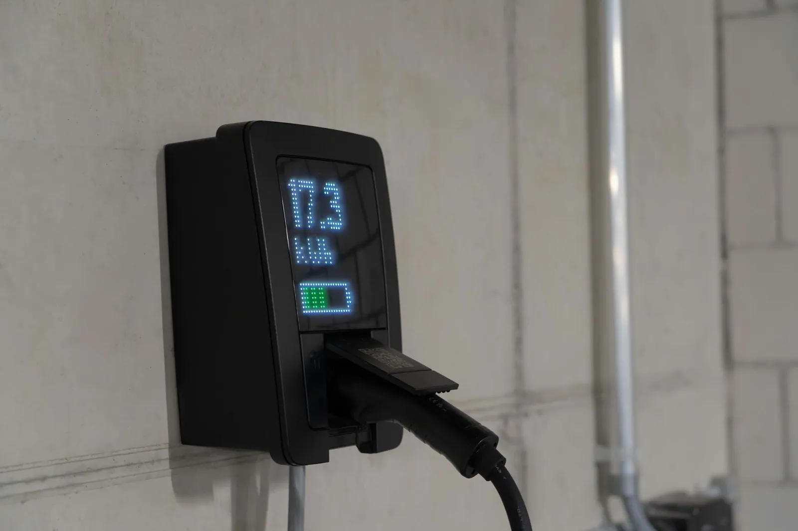 Detailed view of an electric vehicle charging station indoors, showcasing charging technology. Stock photo illustrating Axis Solutions' product launched story.