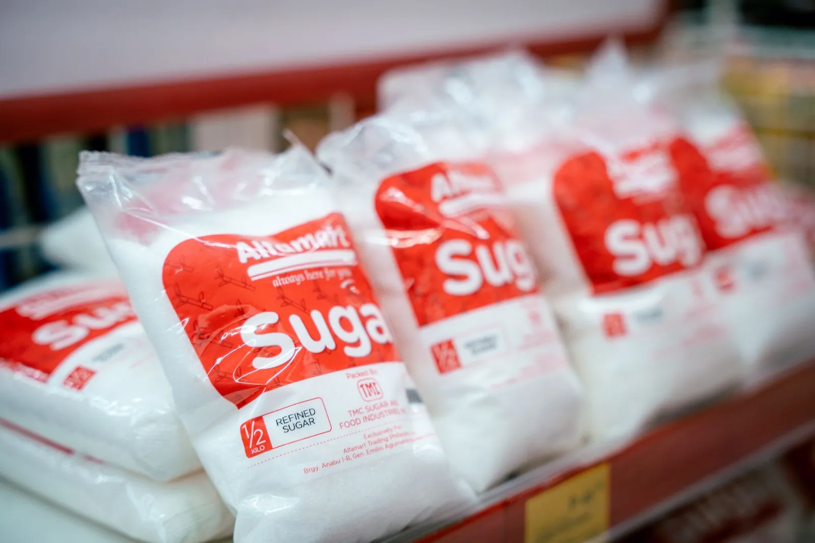 Close-up of sugar bags on a grocery store shelf, highlighting product packaging. Stock photo illustrating Milky Mist Dairy Food's product launched story.