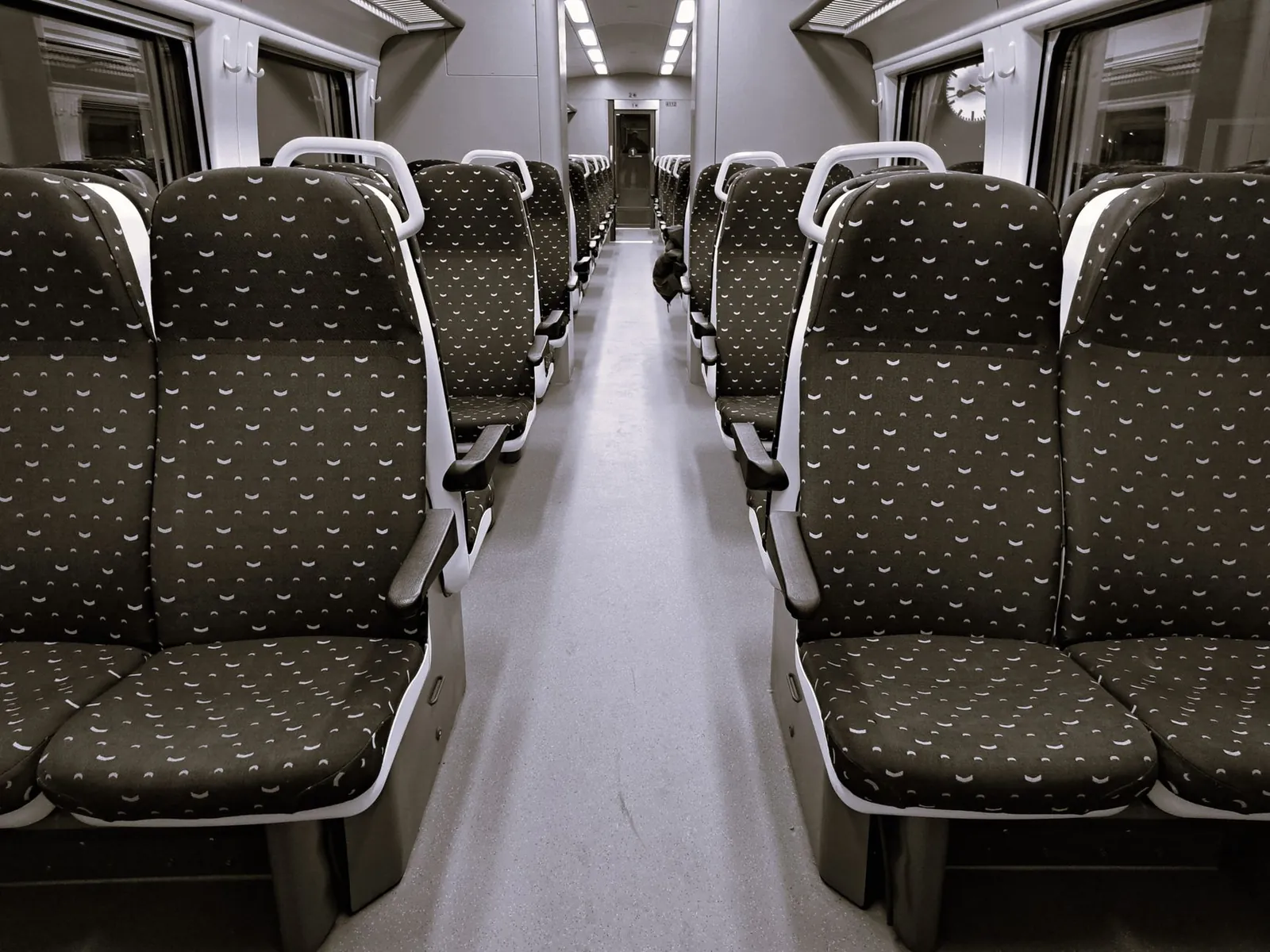 Interior view of empty train with patterned seats, ideal for travel themes. Stock photo illustrating Le Travenues Technology's product launched story.
