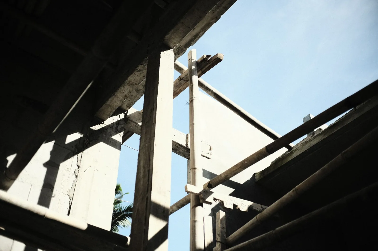 A view of concrete and wooden scaffolding at a construction site under the clear blue sky. Stock photo illustrating RITES's expansion story.