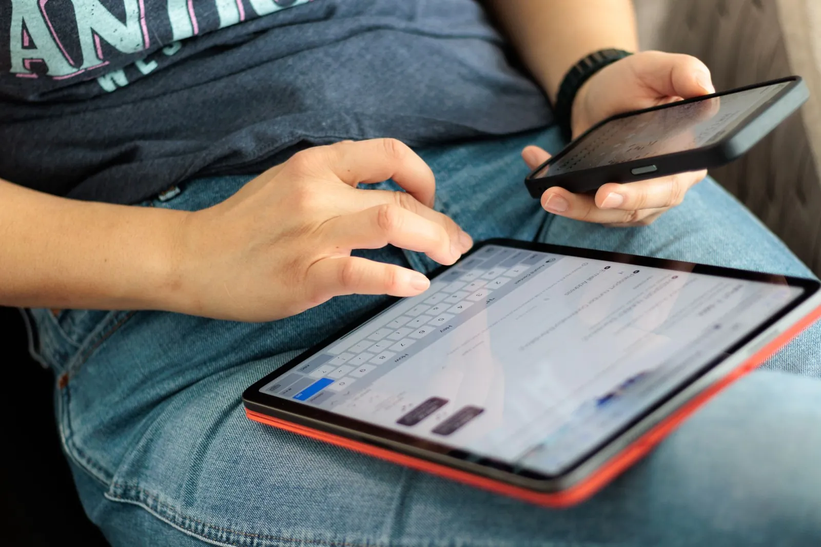 Close-up of adult using a tablet and smartphone indoors, showcasing digital connectivity and multitasking. Stock photo illustrating Fredun Pharmaceuticals' product launched story.