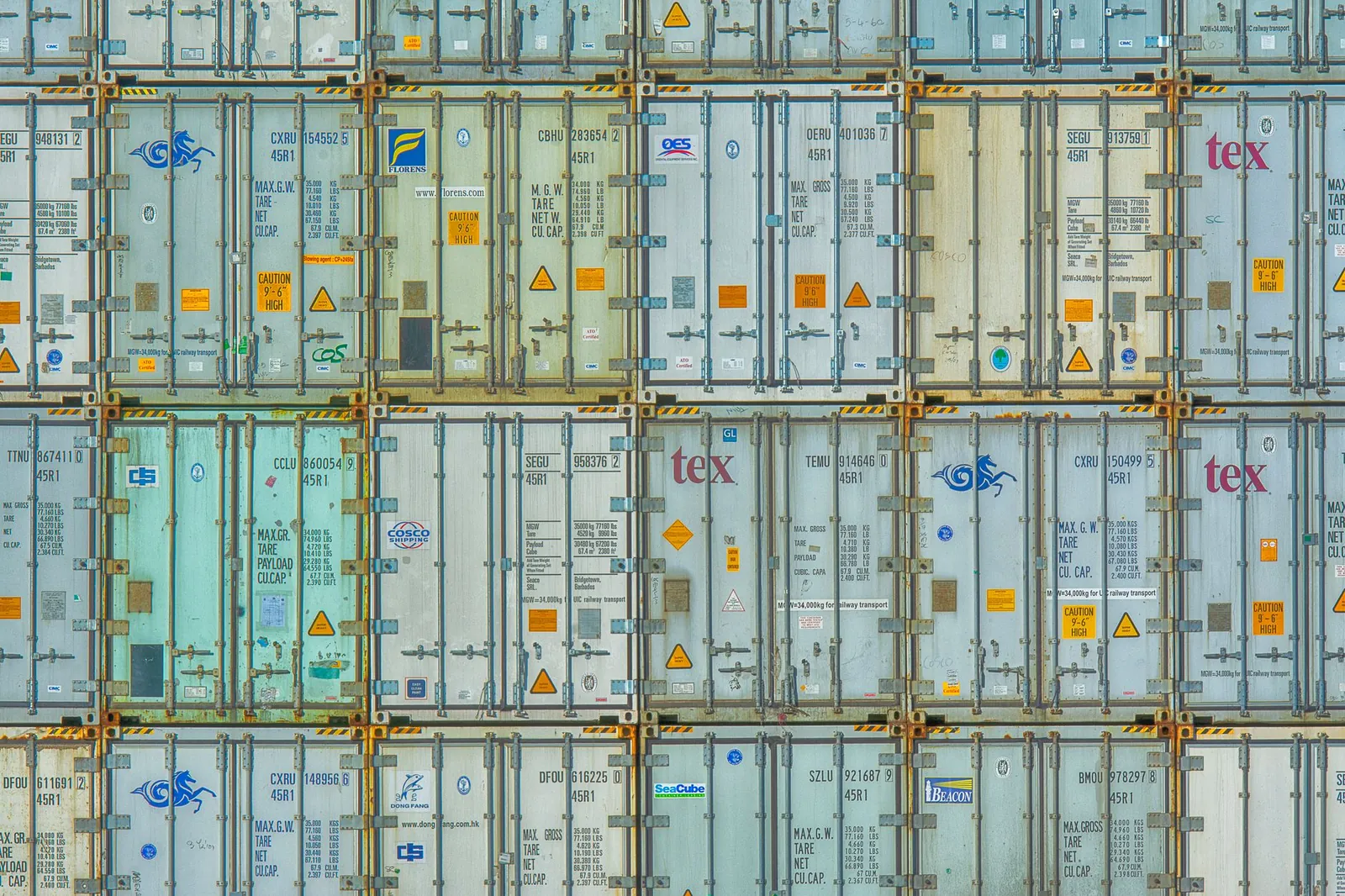 A vibrant display of stacked shipping containers, highlighting industrial organization. Stock photo illustrating Kalyani Cast-Tech's partnership story.