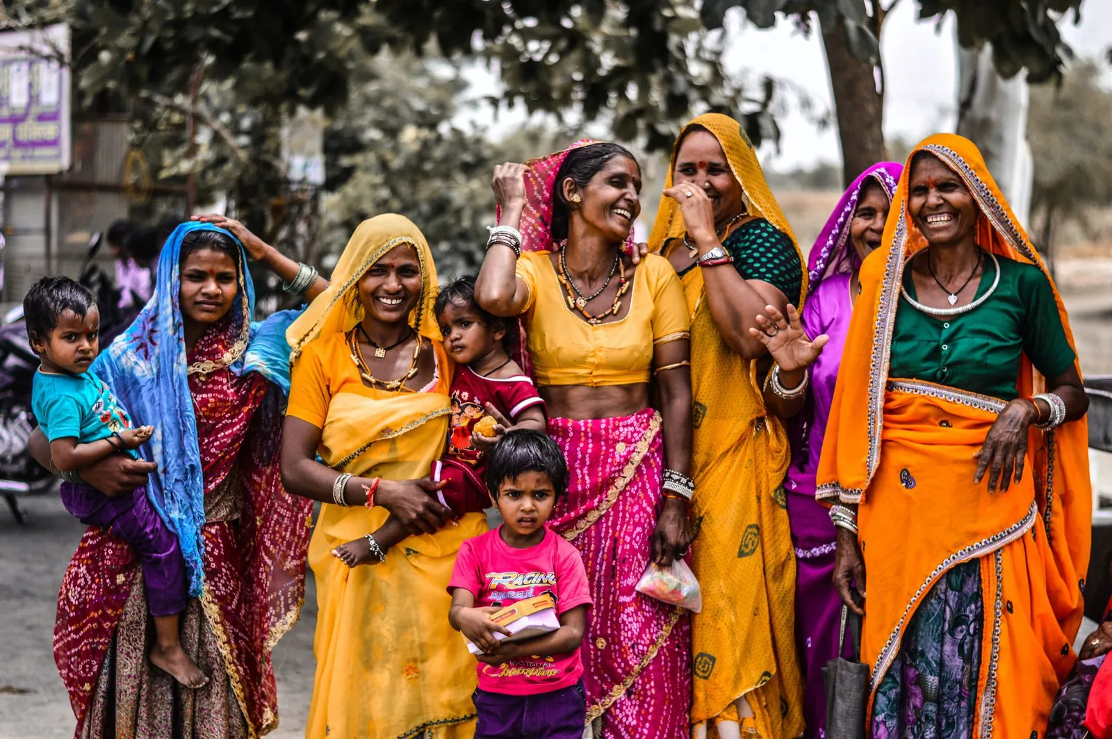 A lively group of women and children in traditional Rajasthani attire, showcasing vibrant culture and joyful expressions. Stock photo illustrating Satin Creditcare Network's fund raise story.