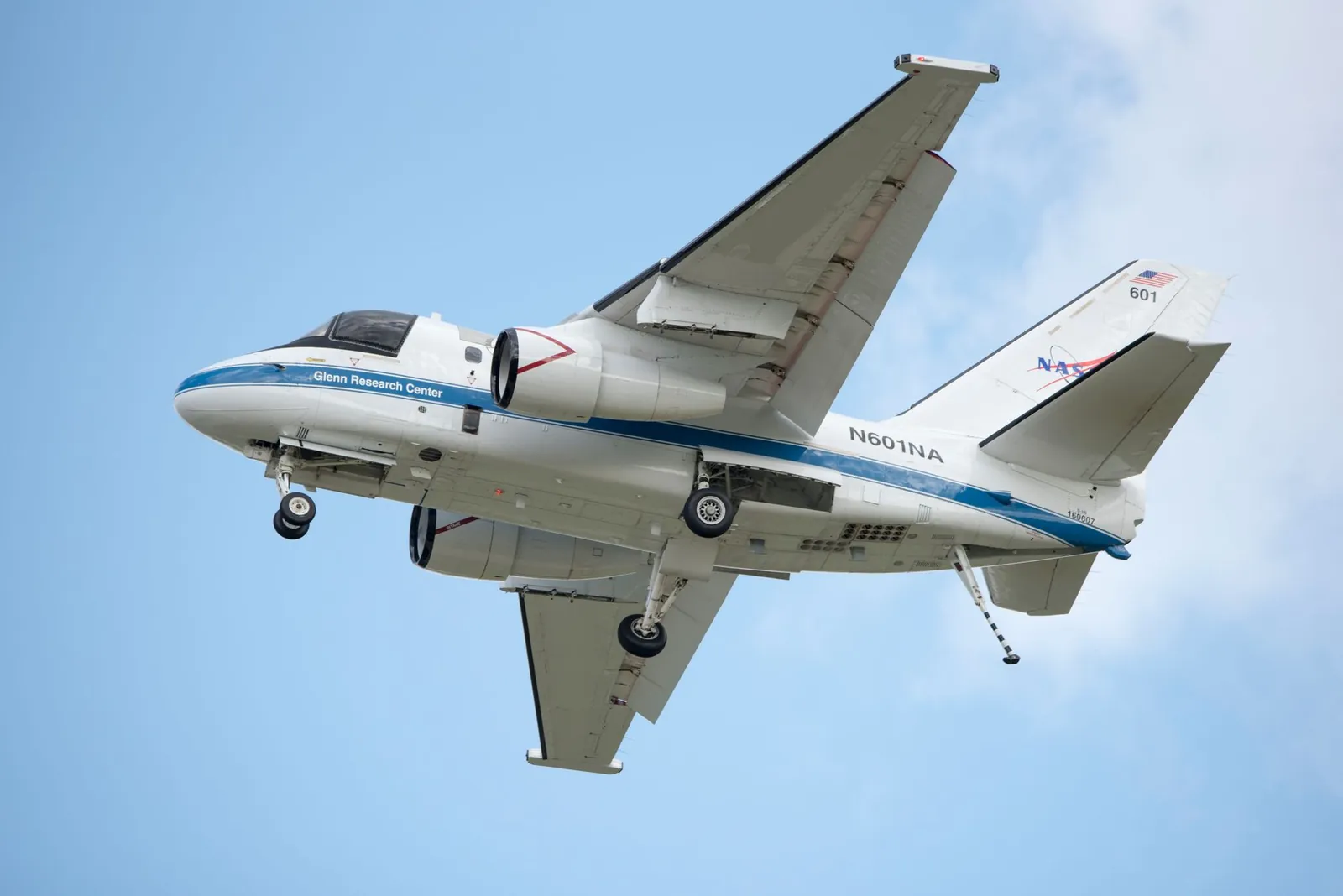 NASA aircraft in flight showcasing engineering marvel against a clear blue sky. Stock photo illustrating Rossell Techsys' earning call story.