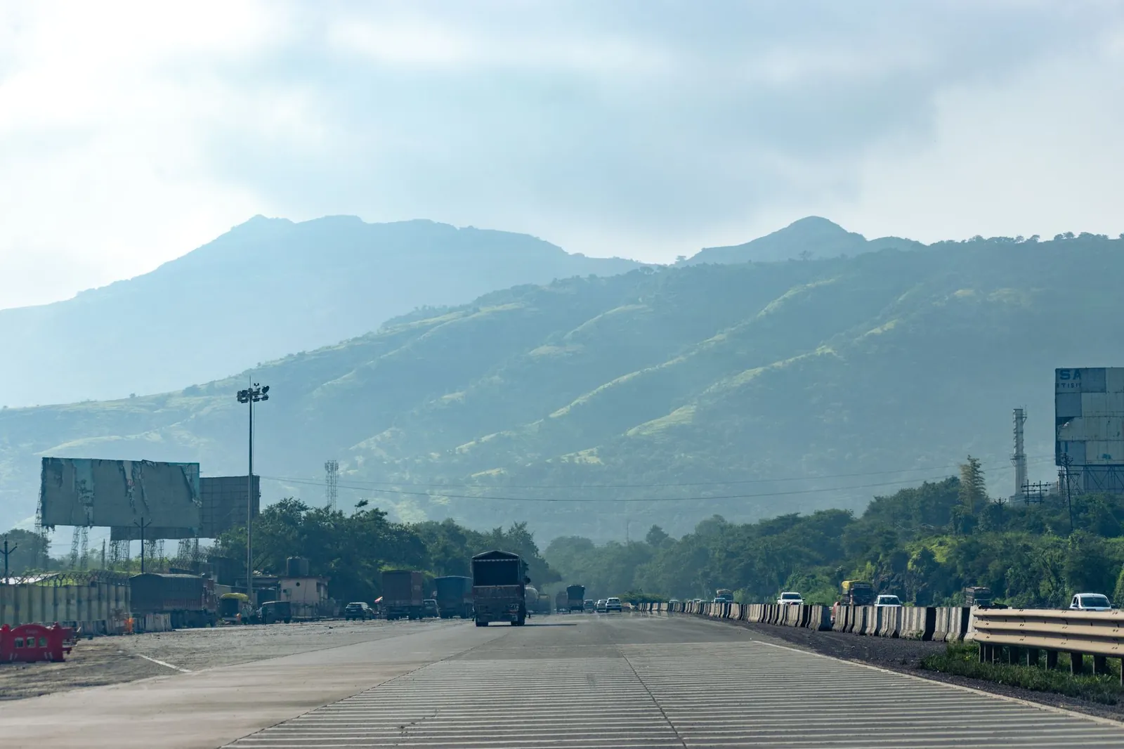 A serene view of a highway with foggy hills in the background, captured in Navi Mumbai, India. Stock photo illustrating Innovision's new order story.