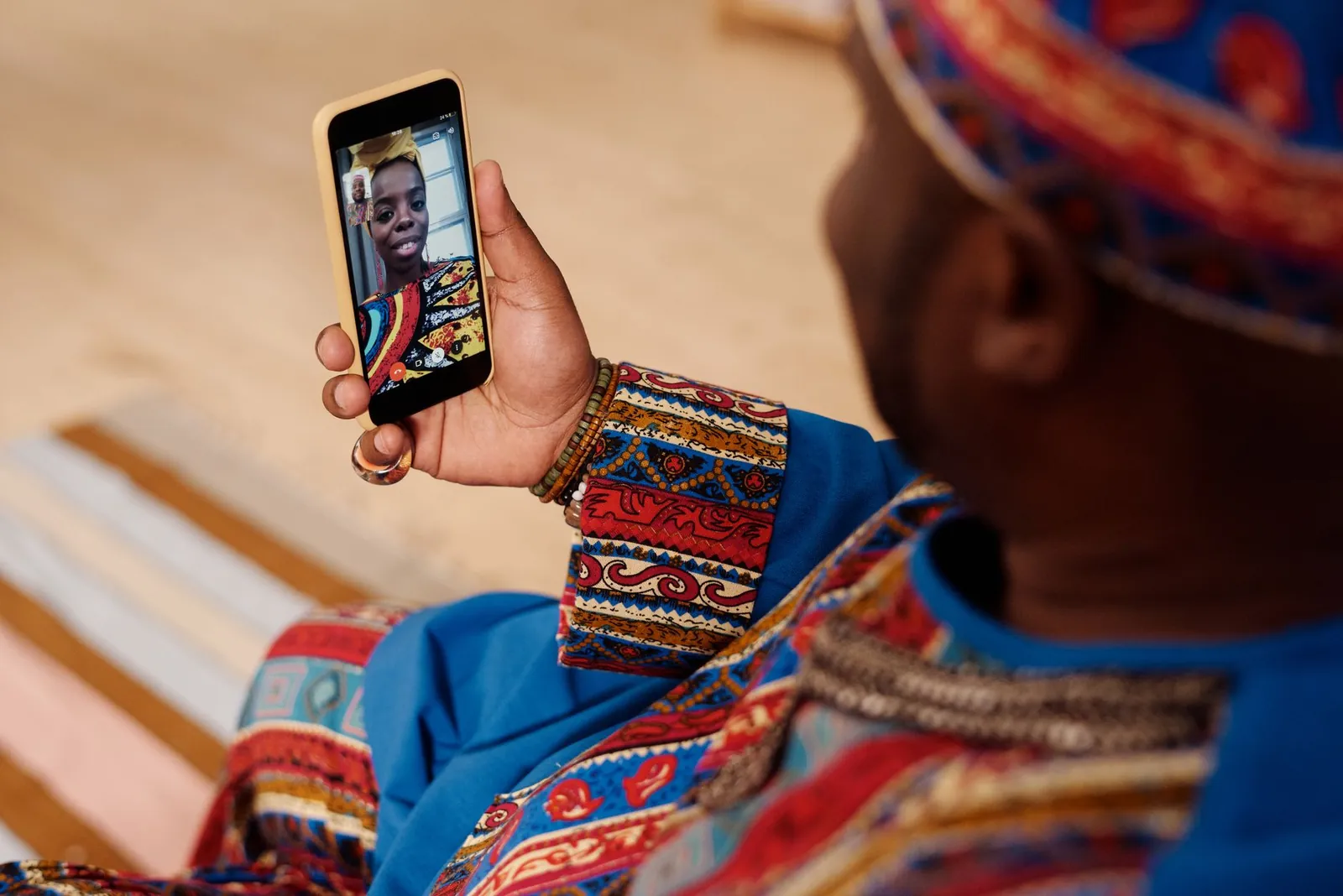 A person wearing colorful attire engages in a video call, celebrating cultural connection and technology. Stock photo illustrating Blue Cloud Softech Solutions' expansion story.